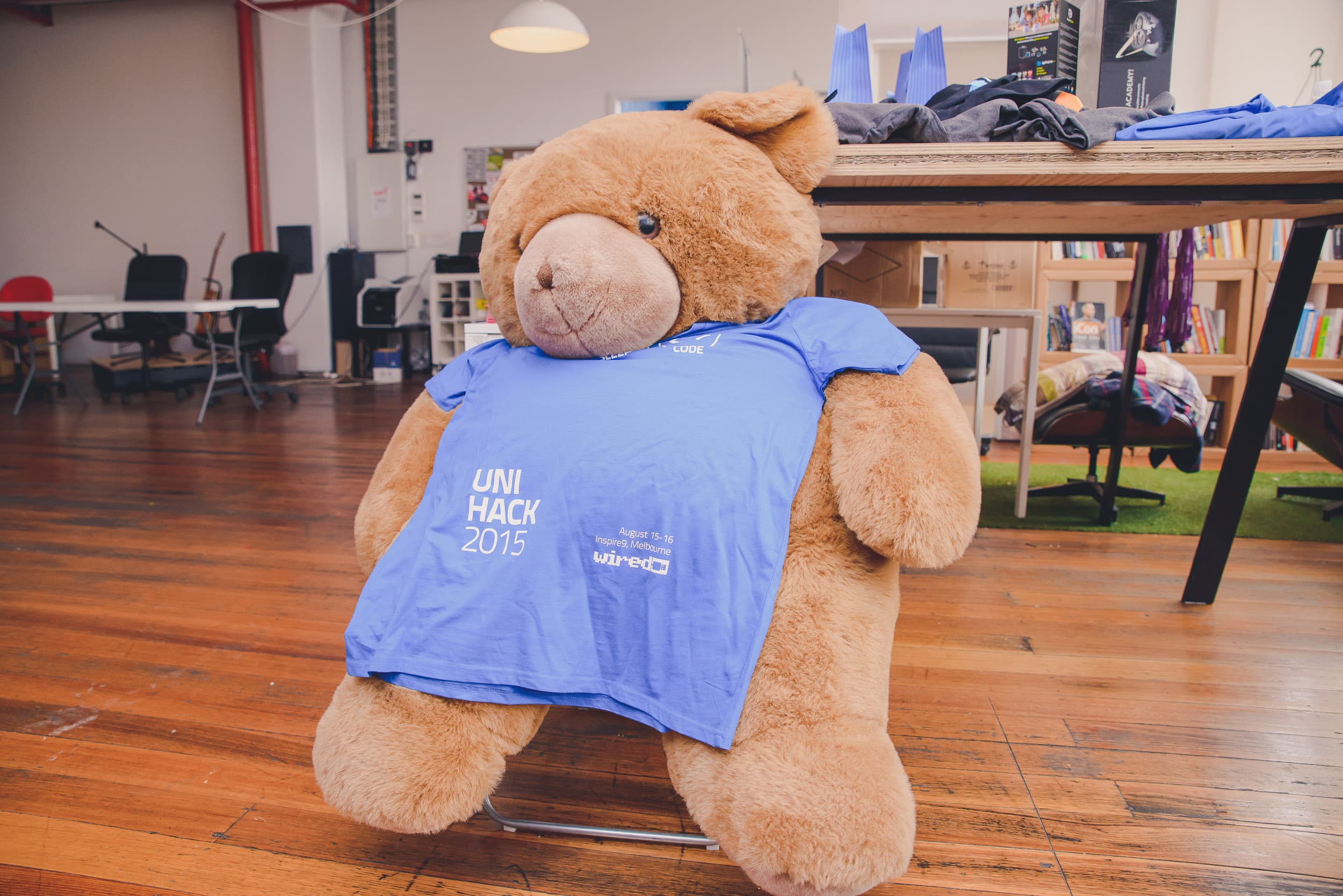 A teddy bear wearing the UNIHACK 2015 shirt