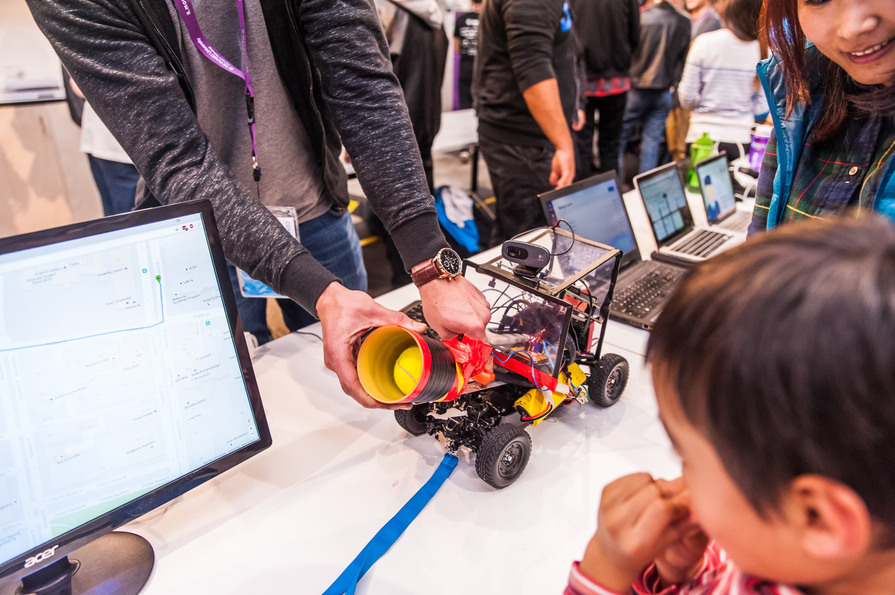 A group presenting their robot to a guest at UNIHACK 2016